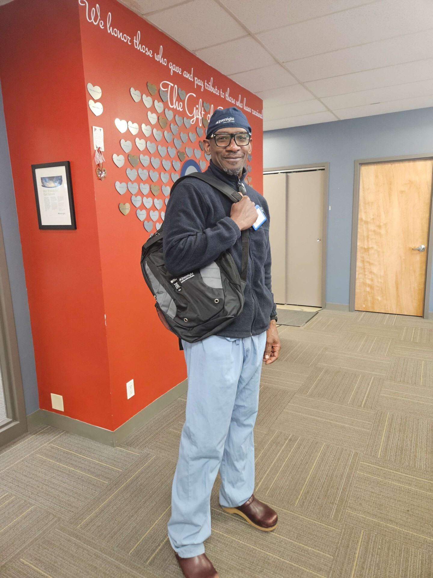 Davis Wilson at the Eversight NJ office holding a backpack before going on a recovery
