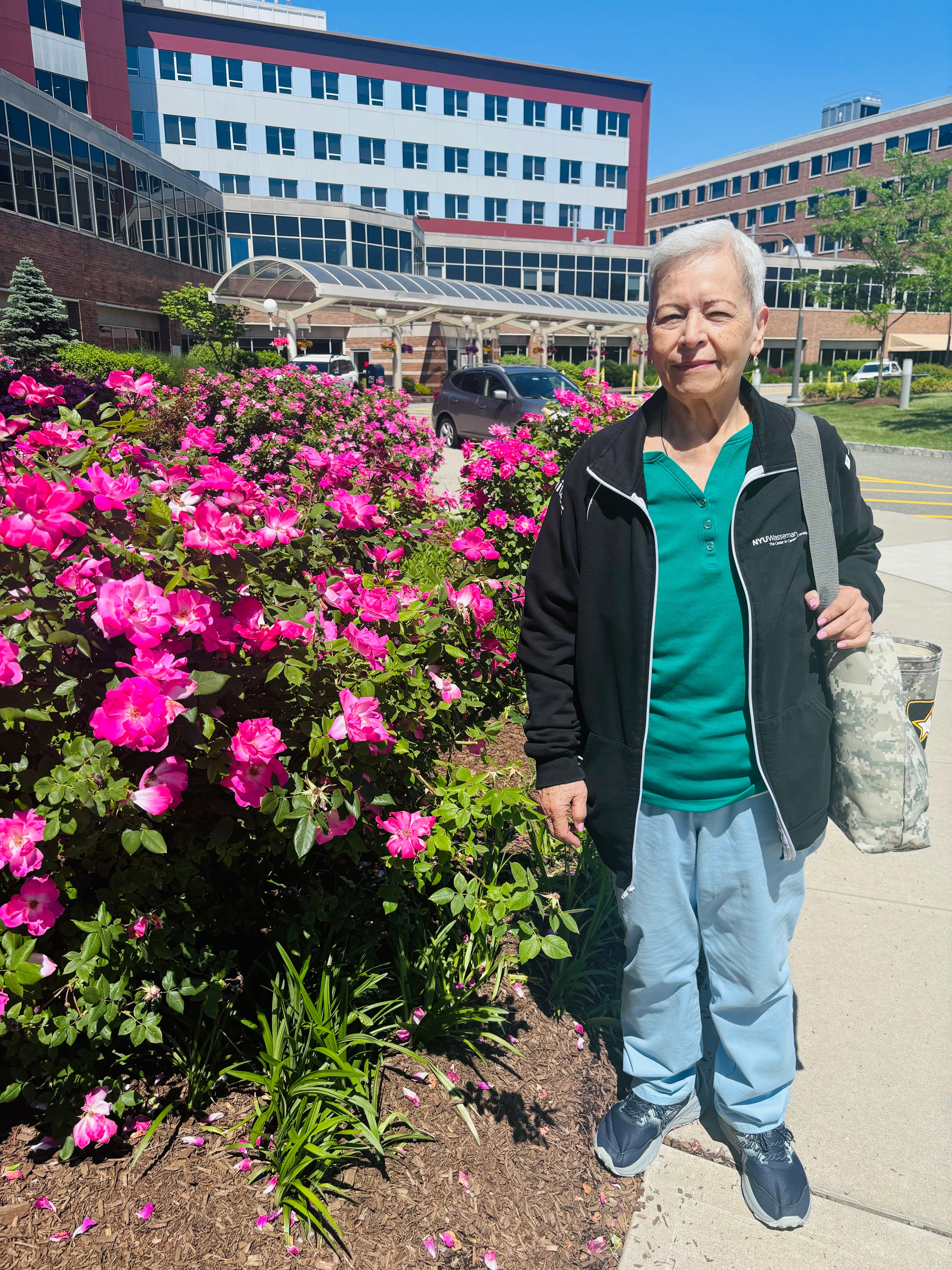 Dora Ballen standing with pink flowers