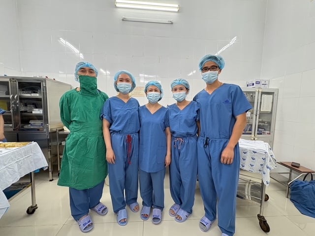 Five surgeons in medical scubs stand in a lab.
