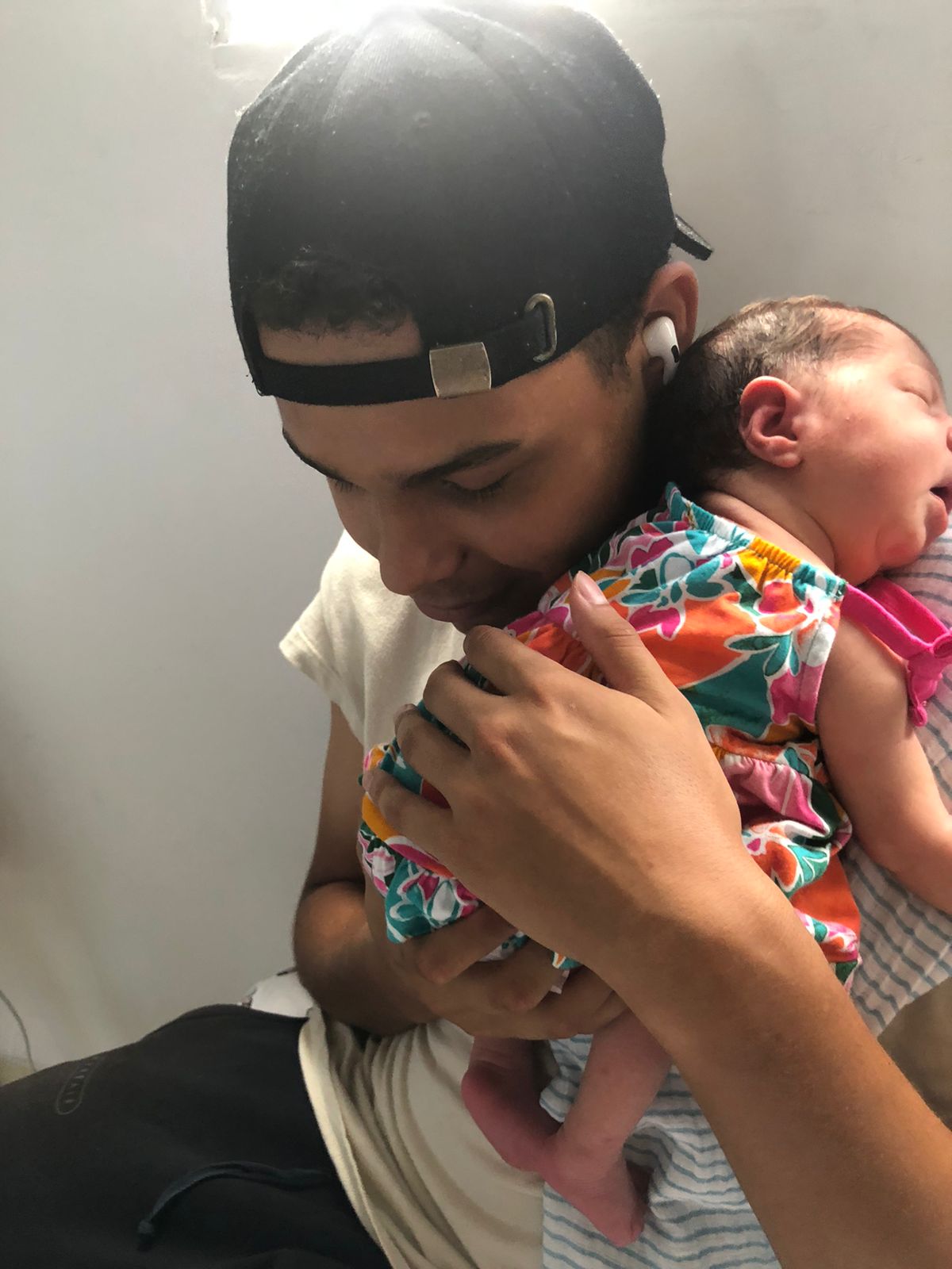 Santiago Villalobos holding a baby.