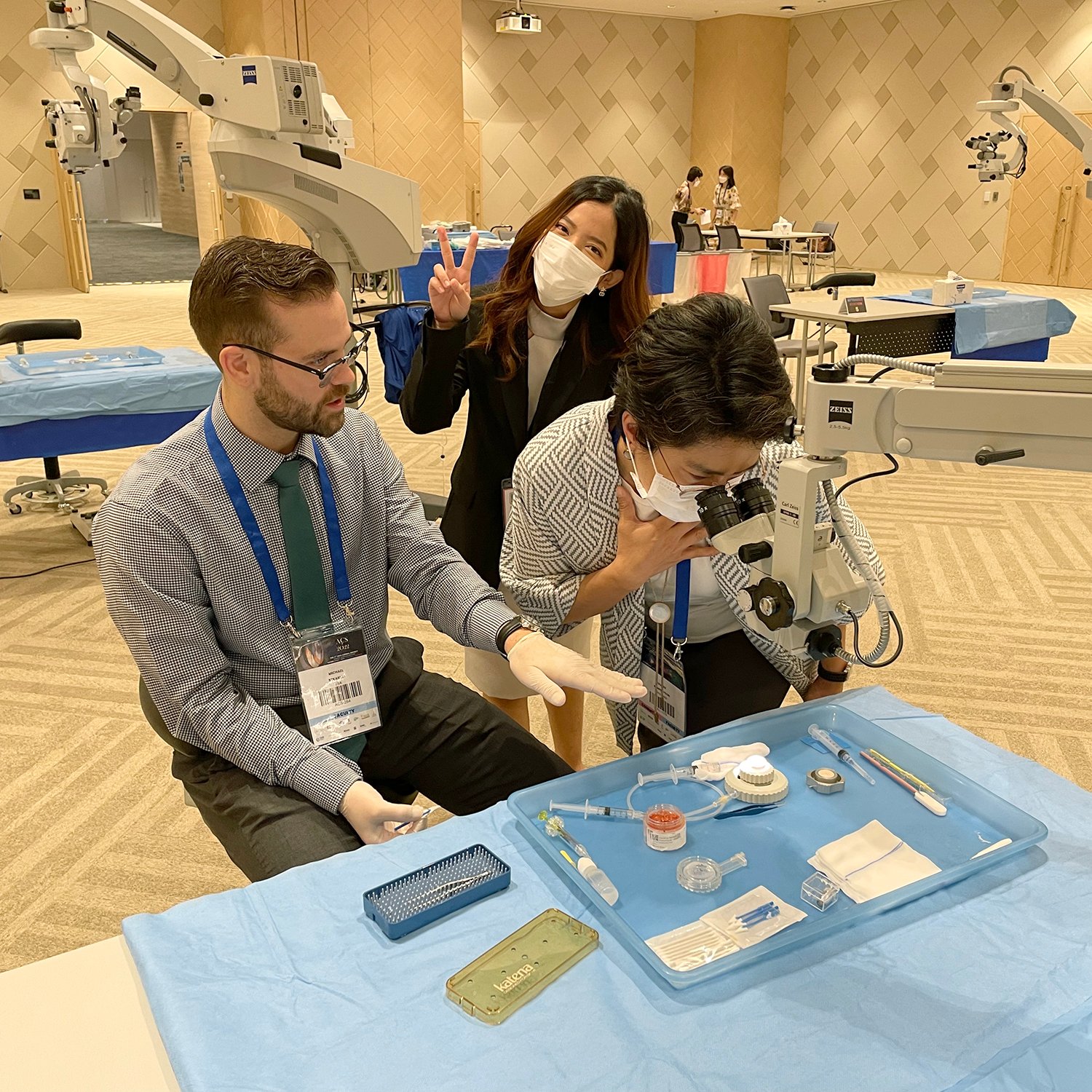 Team looking through microscope Team looking through microscope